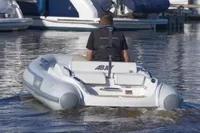 2023 AB Inflatables 350 XP boat on water, rear view with driver.