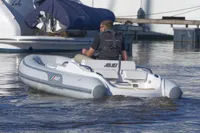 2023 AB Inflatables 350 XP boat on water, rear view with driver.