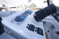 Control panel of 2023 AB Inflatables 350 XP boat, featuring gauges and switches.