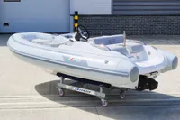 2023 AB Inflatables 350 XP boat on a wheeled platform, outdoor setting.