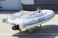 2023 AB Inflatables 350 XP boat on a trailer, displayed outdoors.