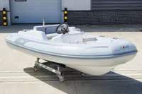 2023 AB Inflatables 350 XP boat on a wheeled stand, outdoor setting.