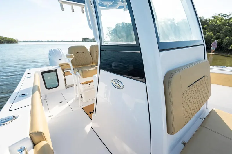  Yacht Photos Pics Manufacturer Provided Image: 2025 Sportsman Open 252 Center Console boat on calm water, featuring beige seating.