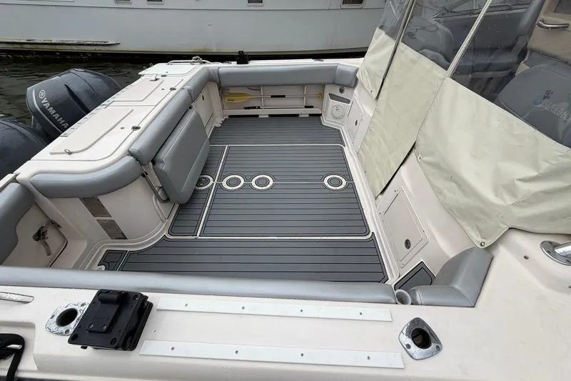  Yacht Photos Pics 2004 Grady-White Express 330 boat deck with Yamaha engines, featuring spacious seating and storage.
