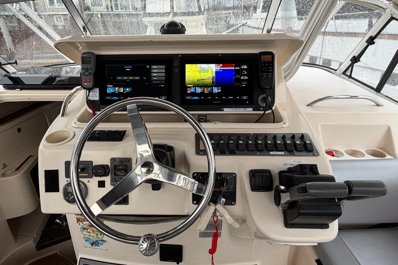  Yacht Photos Pics 2004 Grady-White Express 330 helm with dual displays and steering wheel.