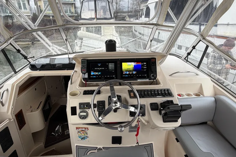  Yacht Photos Pics 2004 Grady-White Express 330 boat cockpit with navigation controls and steering wheel.