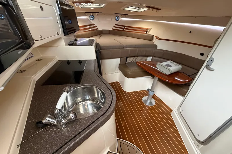  Yacht Photos Pics 2004 Grady-White Express 330 cabin interior with kitchenette, seating, and sleeping area.