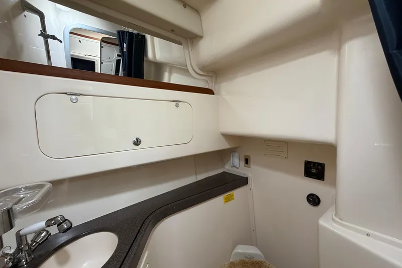  Yacht Photos Pics 2004 Grady-White Express 330 boat interior with sink and storage cabinet.