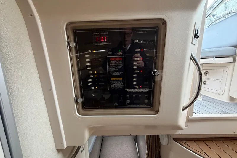  Yacht Photos Pics Control panel of a 2004 Grady-White Express 330 boat, showing electrical switches and indicators.