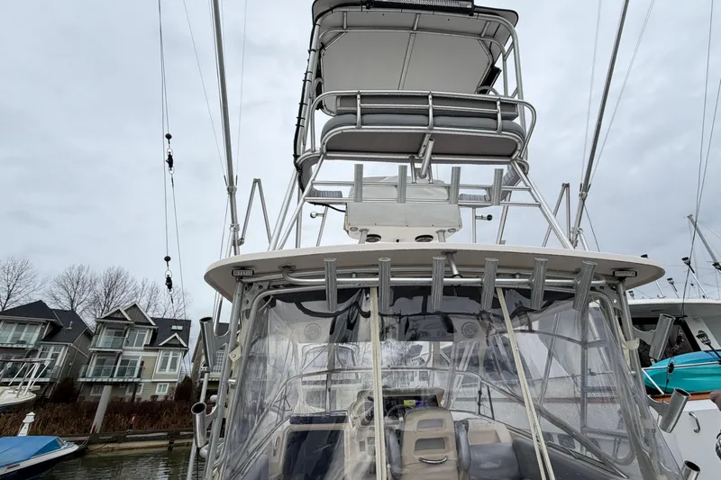  Yacht Photos Pics 2004 Grady-White Express 330 boat with tower, docked near waterfront homes.