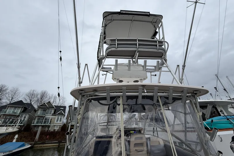  Yacht Photos Pics 2004 Grady-White Express 330 boat with tower, docked near waterfront homes.