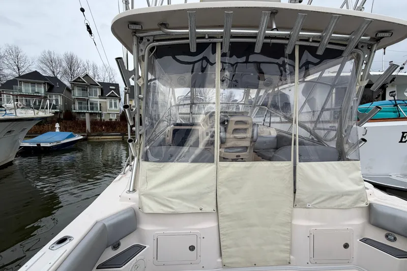  Yacht Photos Pics 2004 Grady-White Express 330 boat docked, featuring covered cockpit and waterfront homes in background.