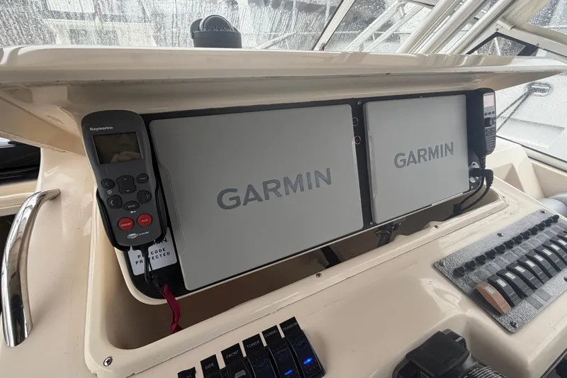 Yacht Photos Pics 2004 Grady-White Express 330 helm with Garmin navigation displays and Raymarine controls.