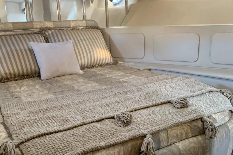 Jade Yacht Photos Pics Luxurious bedroom interior of 1998 Magnum 50 Bestia yacht with elegant bedding.