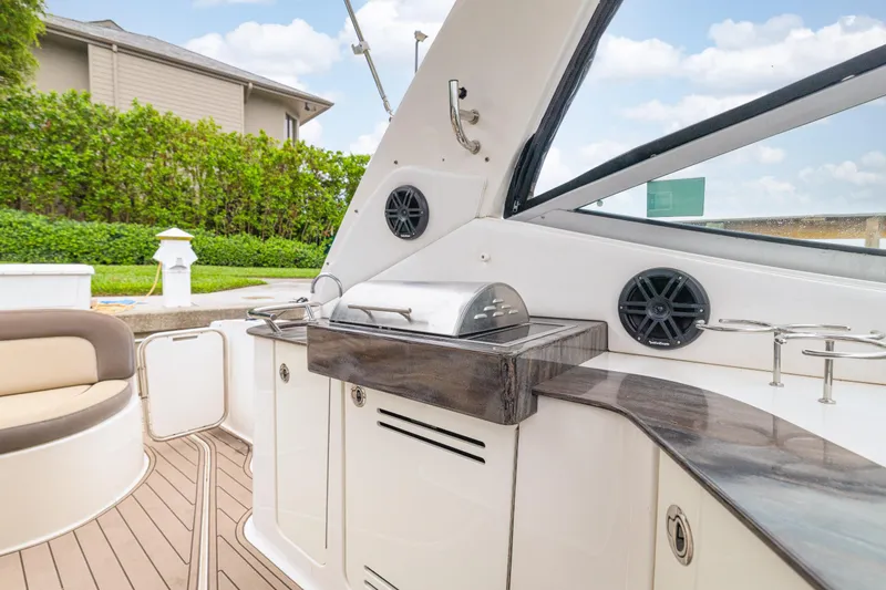  Yacht Photos Pics 2014 Sea Ray 330 Sundancer boat interior with grill and seating area.