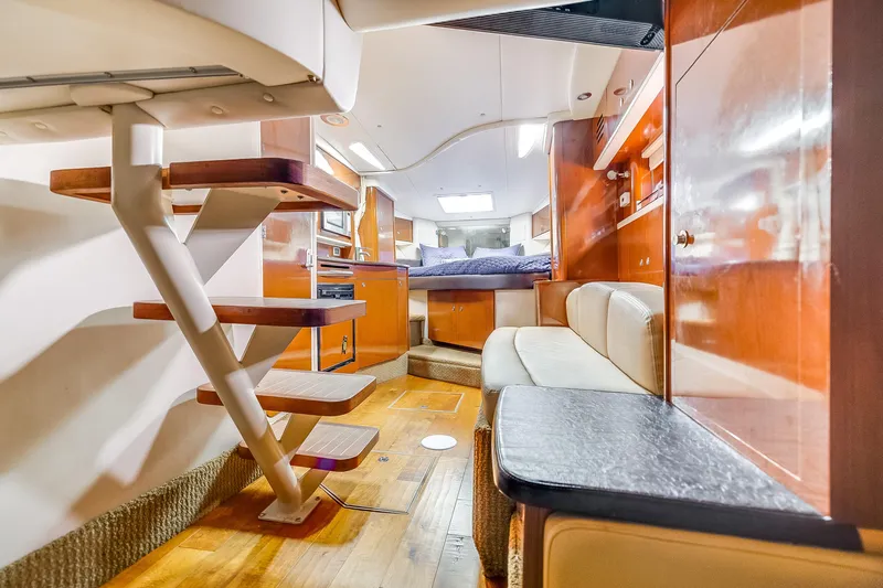  Yacht Photos Pics 2014 Sea Ray 330 Sundancer interior with wooden stairs, cozy seating, and modern amenities.
