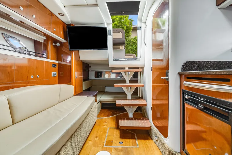  Yacht Photos Pics Luxurious interior of 2014 Sea Ray 330 Sundancer yacht with modern amenities and wooden finishes.