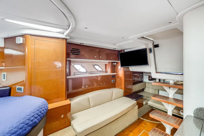  Yacht Photos Pics 2014 Sea Ray 330 Sundancer cabin interior with wood finishes, sofa, and mounted TV.