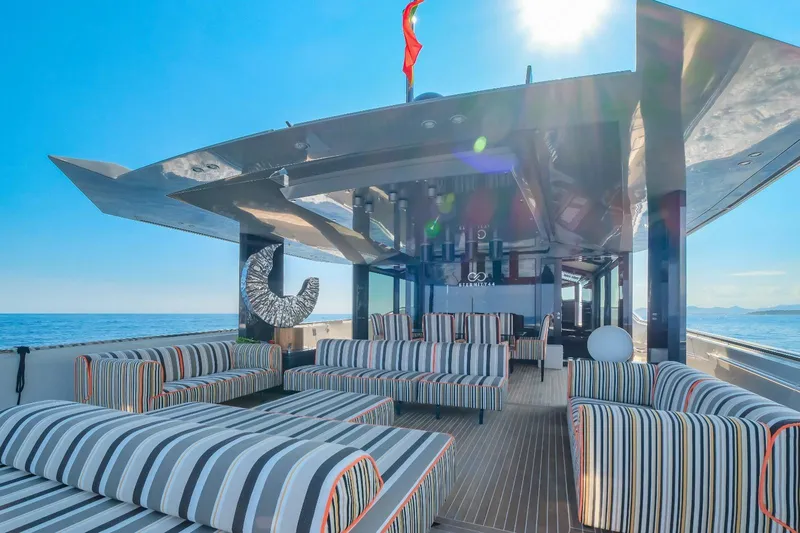 Eternity 44 Yacht Photos Pics Luxurious 2010 Arcadia Yachts 85 with stylish striped seating on deck, under sunny skies.