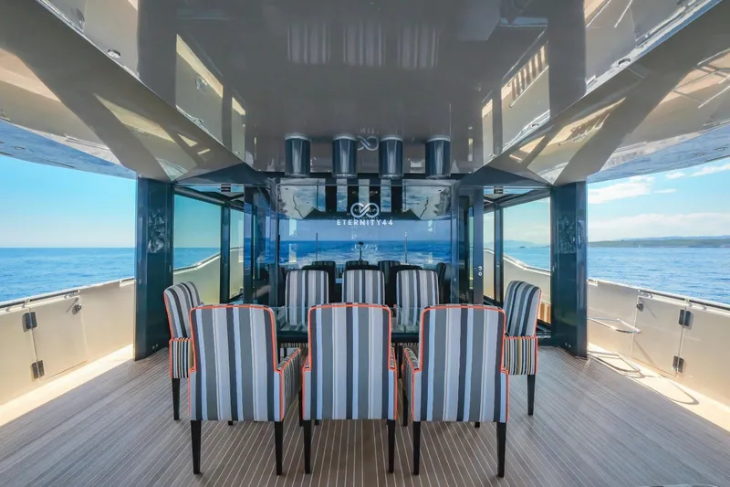 Eternity 44 Yacht Photos Pics Luxurious Arcadia Yachts 85 interior, 2010 model, featuring elegant striped chairs and ocean view.