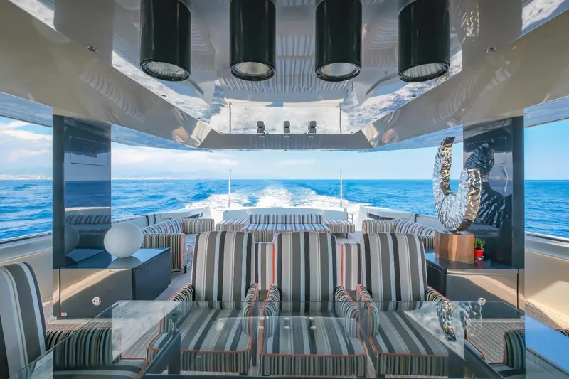 Eternity 44 Yacht Photos Pics Luxurious interior of 2010 Arcadia Yachts 85 with striped seating and ocean view.