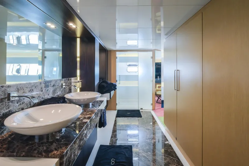 Eternity 44 Yacht Photos Pics Luxurious bathroom interior of 2010 Arcadia Yachts 85, featuring dual sinks and marble countertops.