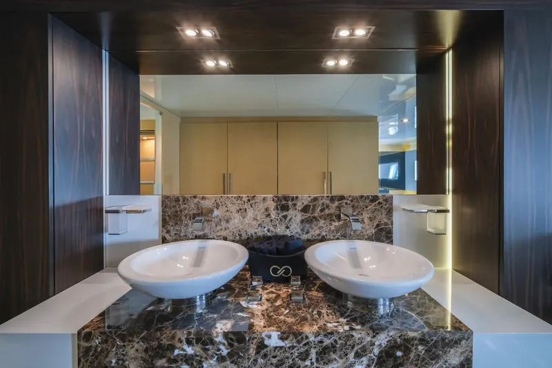 Eternity 44 Yacht Photos Pics Luxurious bathroom on 2010 Arcadia Yachts 85 with dual sinks and marble countertop.