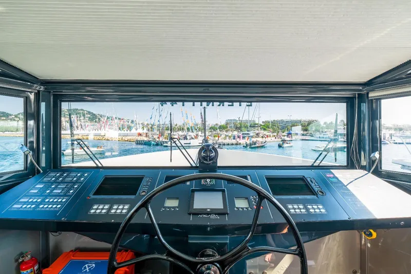 Eternity 44 Yacht Photos Pics Cockpit view of 2010 Arcadia Yachts 85, showcasing navigation controls and marina scenery.