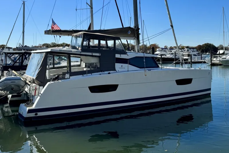  Yacht Photos Pics 2017 Fountaine Pajot Lucia 40 catamaran docked in a marina, side view.