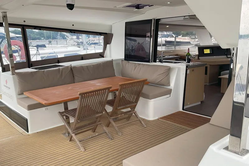  Yacht Photos Pics 2017 Fountaine Pajot Lucia 40 yacht interior with dining area and kitchenette.
