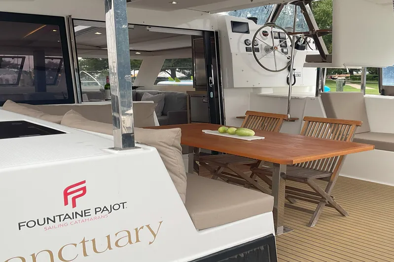  Yacht Photos Pics 2017 Fountaine Pajot Lucia 40 catamaran with elegant outdoor seating and helm station.