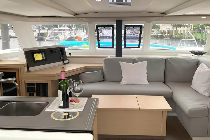  Yacht Photos Pics Luxurious interior of 2017 Fountaine Pajot Lucia 40 catamaran with cozy seating and wine setup.