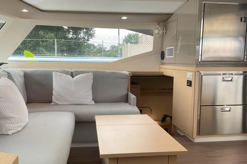  Yacht Photos Pics Interior of 2017 Fountaine Pajot Lucia 40 catamaran, featuring modern seating and stainless steel appliances.
