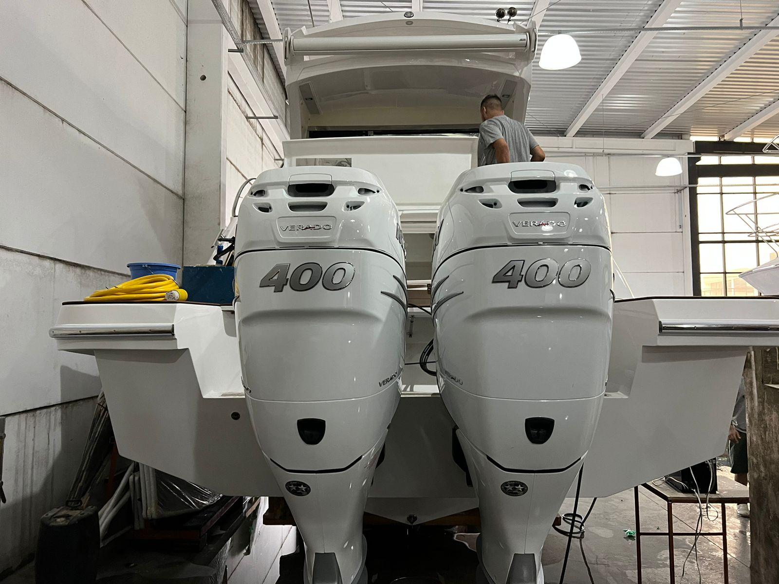 2023 Evolve 400HT boat with dual 400 horsepower engines in a garage setting.