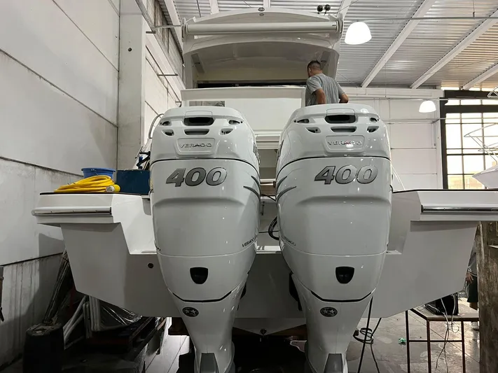 Elena Yacht Photos Pics 2023 Evolve 400HT boat with dual 400 horsepower engines in a garage setting.