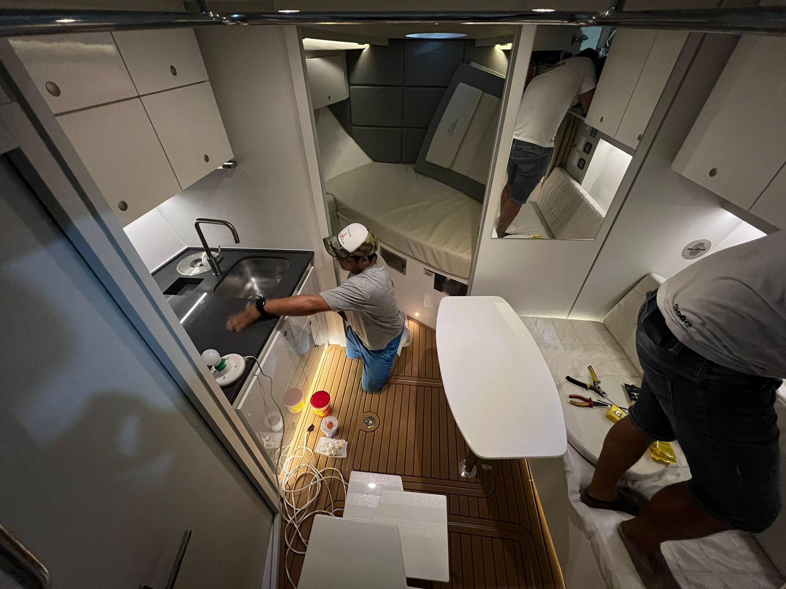Interior of 2023 Evolve 400HT yacht with modern kitchen and seating area.