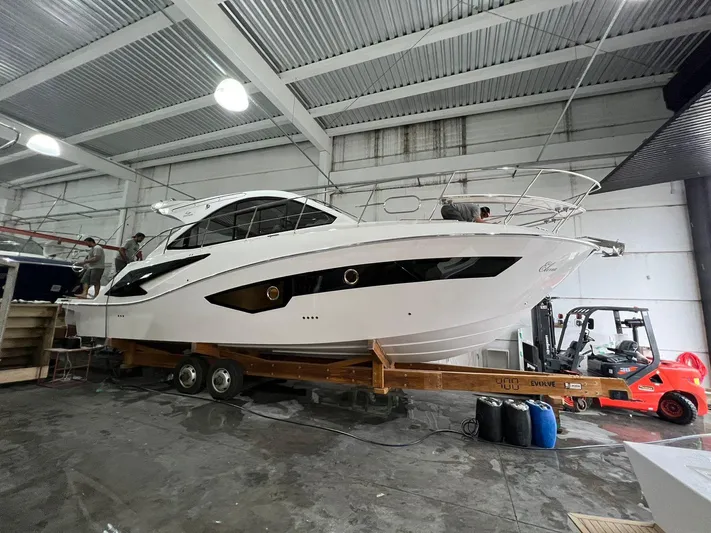 Elena Yacht Photos Pics 2023 Evolve 400HT yacht in a warehouse, displayed on a trailer.