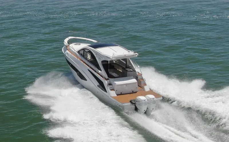 Elena Yacht Photos Pics 2023 Evolve 400HT boat cruising on open water, showcasing sleek design and powerful engines.