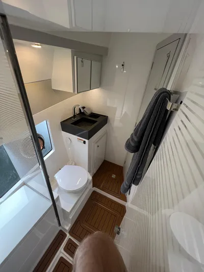 Elena Yacht Photos Pics Modern bathroom in 2023 Evolve 400HT yacht with sleek fixtures and wooden flooring.