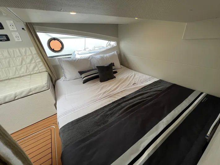 Elena Yacht Photos Pics Luxurious cabin interior of 2023 Evolve 400HT yacht with elegant bedding and modern design.