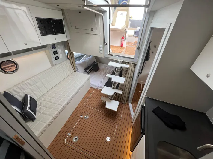 Elena Yacht Photos Pics Interior of 2023 Evolve 400HT yacht with modern seating and wooden flooring.