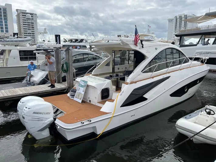 Elena Yacht Photos Pics 2023 Evolve 400HT yacht docked, featuring sleek design and Mercury outboard engine.