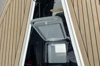 Open hatch on Rand Source 22 boat, showcasing interior storage, 2023 model.