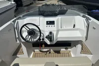 2023 Rand Source 22 boat dashboard with steering wheel and controls.