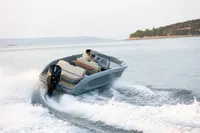2023 Rand Source 22 boat cruising on open water, creating a wake.