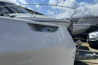 Close-up of 2023 Rand Source 22 boat detail, with other boats in the background.