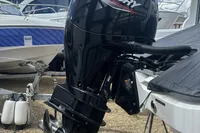 Outboard motor on a Rand Source 22 boat, 2023 model, in a marina setting.