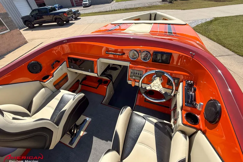  Yacht Photos Pics Interior of a 2012 DCB 28 Extreme boat with vibrant orange dashboard and modern controls.