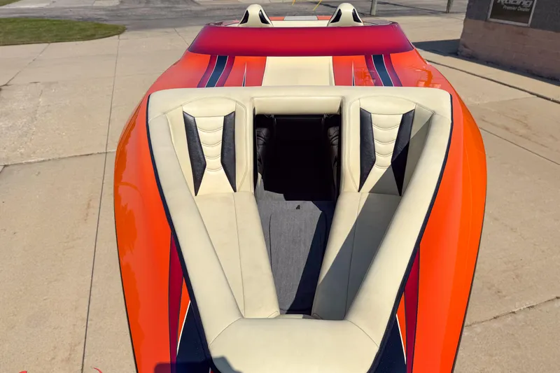  Yacht Photos Pics 2012 DCB 28 Extreme boat with vibrant orange and white seating on a concrete surface.