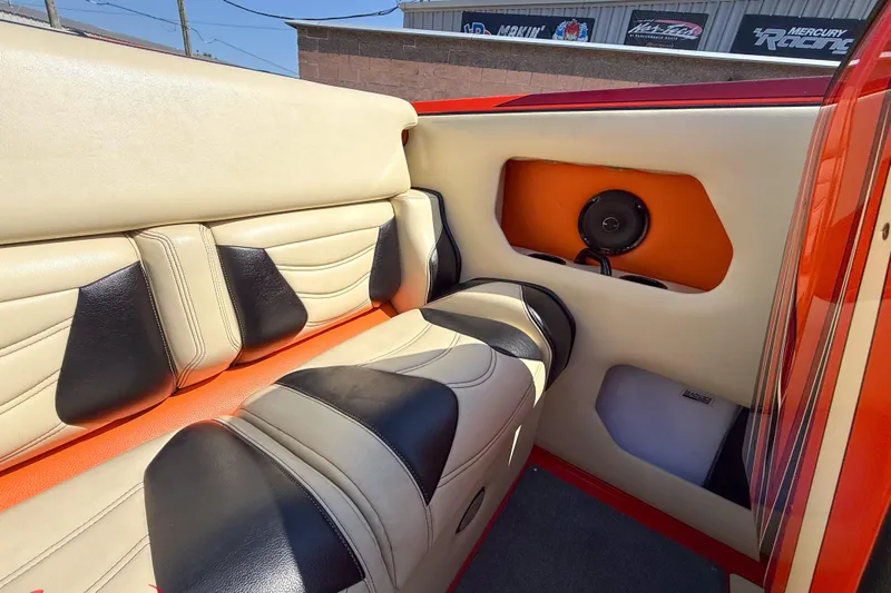  Yacht Photos Pics 2012 DCB 28 Extreme boat interior with beige and black seating, speaker, and orange accents.